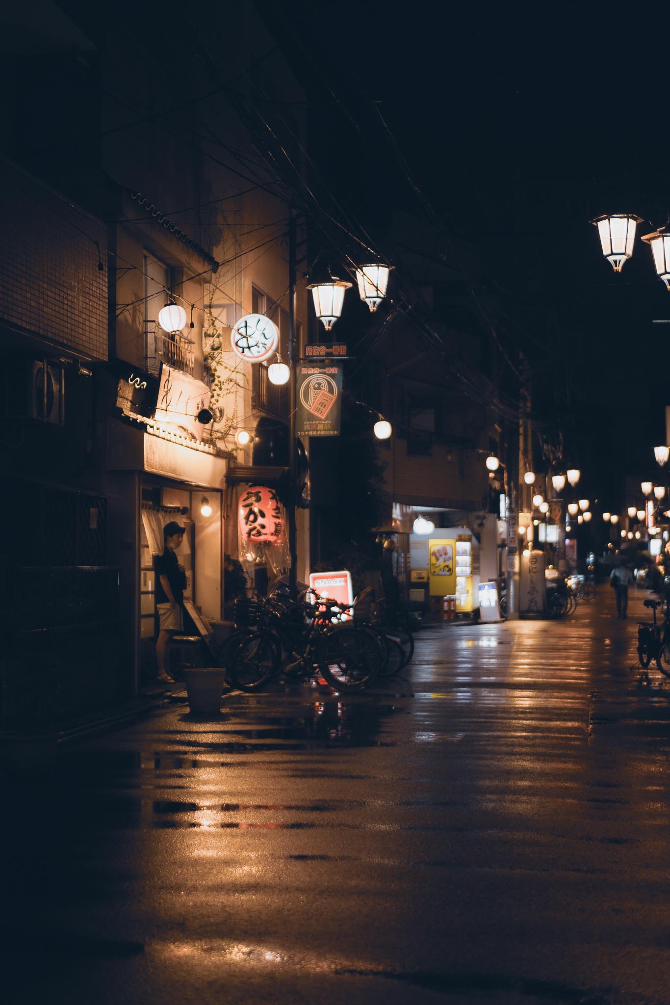 Asagaya shotengai street at night — lanterns and rain wet pavement Tokyo