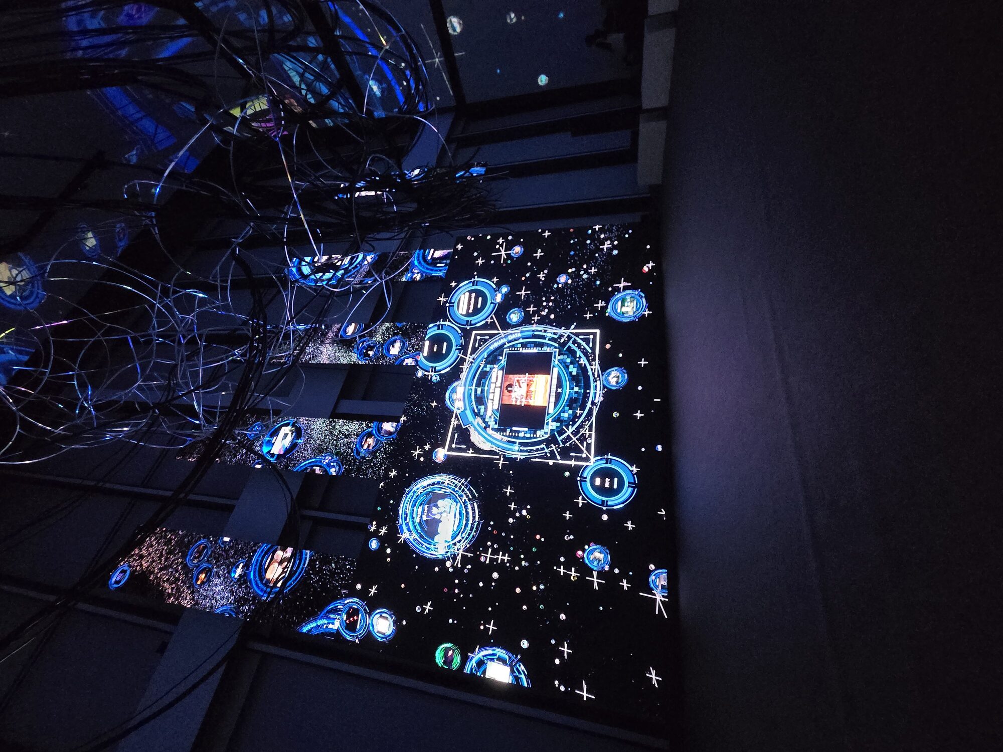 Immersive digital installation at Ghost in the Shell The Exhibition — blue network projection covering floor, viewed from above