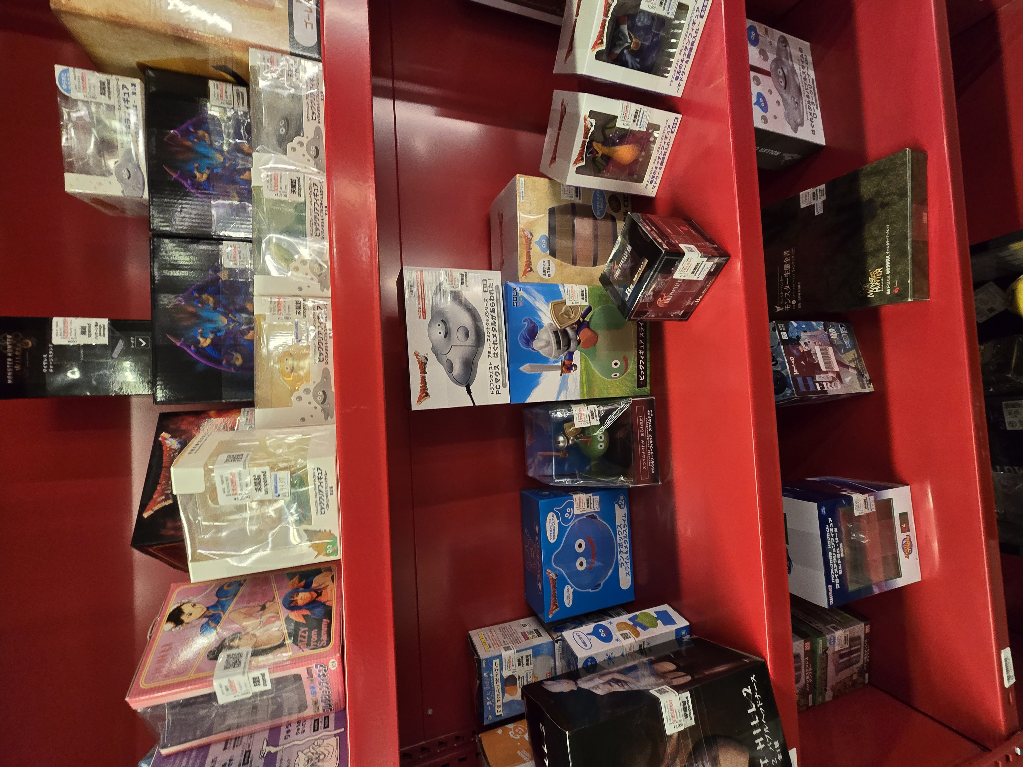 Red shelves with Dragon Quest collectibles and figures at Mikado Ikebukuro