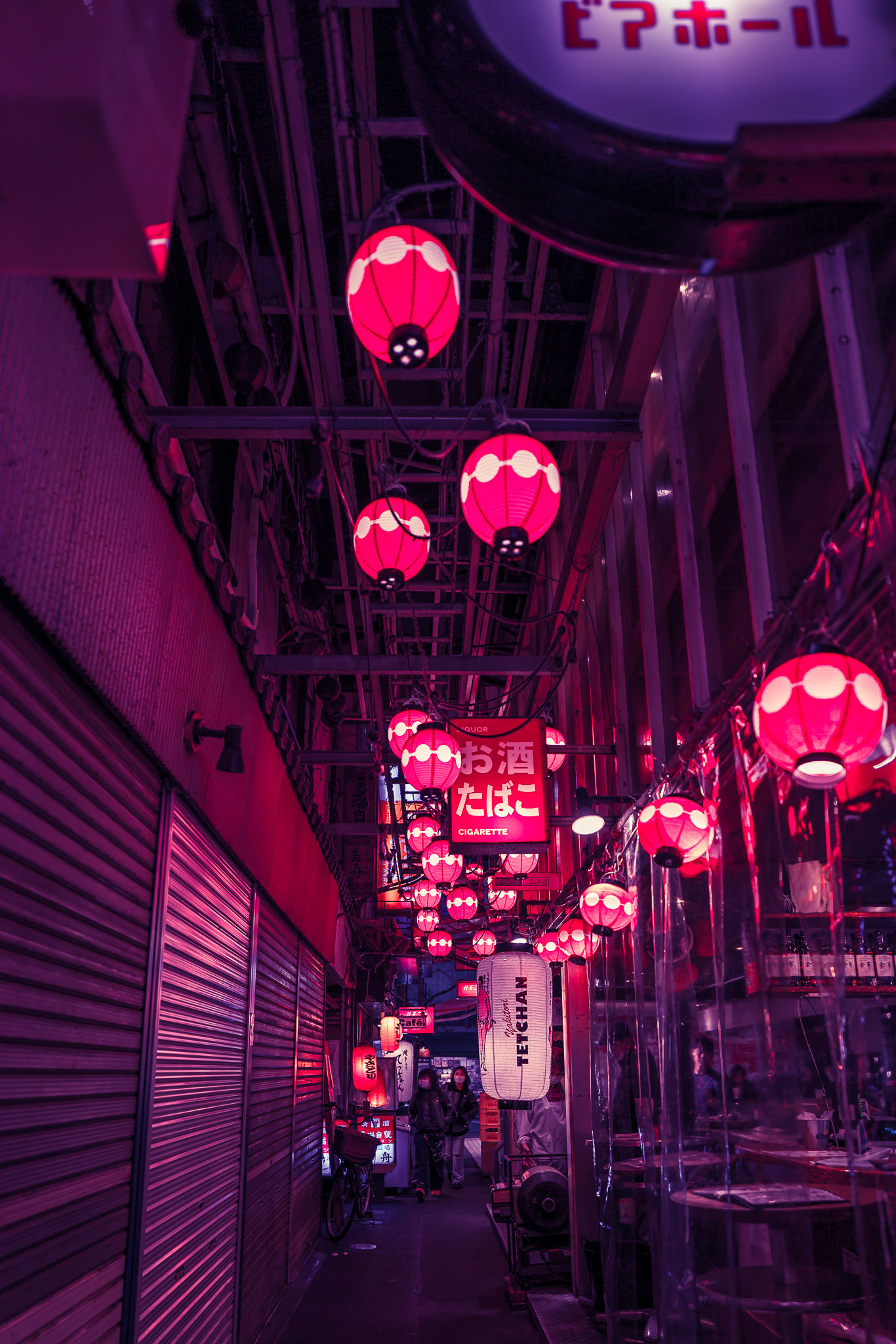 Rows of red paper lanterns hanging above a narrow alley in Harmonica Yokocho, Kichijoji, at night