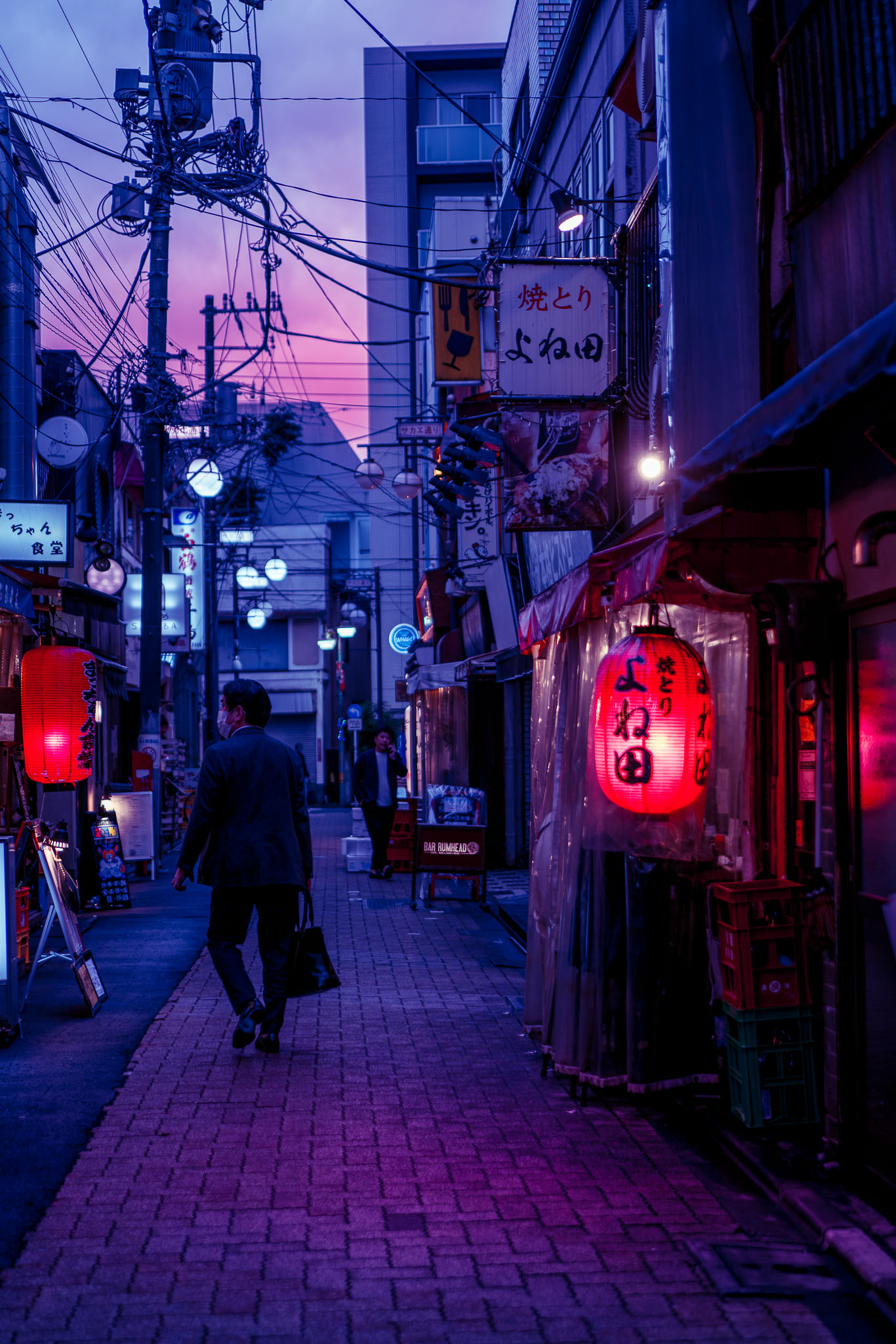 Ogikubo backstreet at dusk — salaryman walking past red lantern yakitori bar