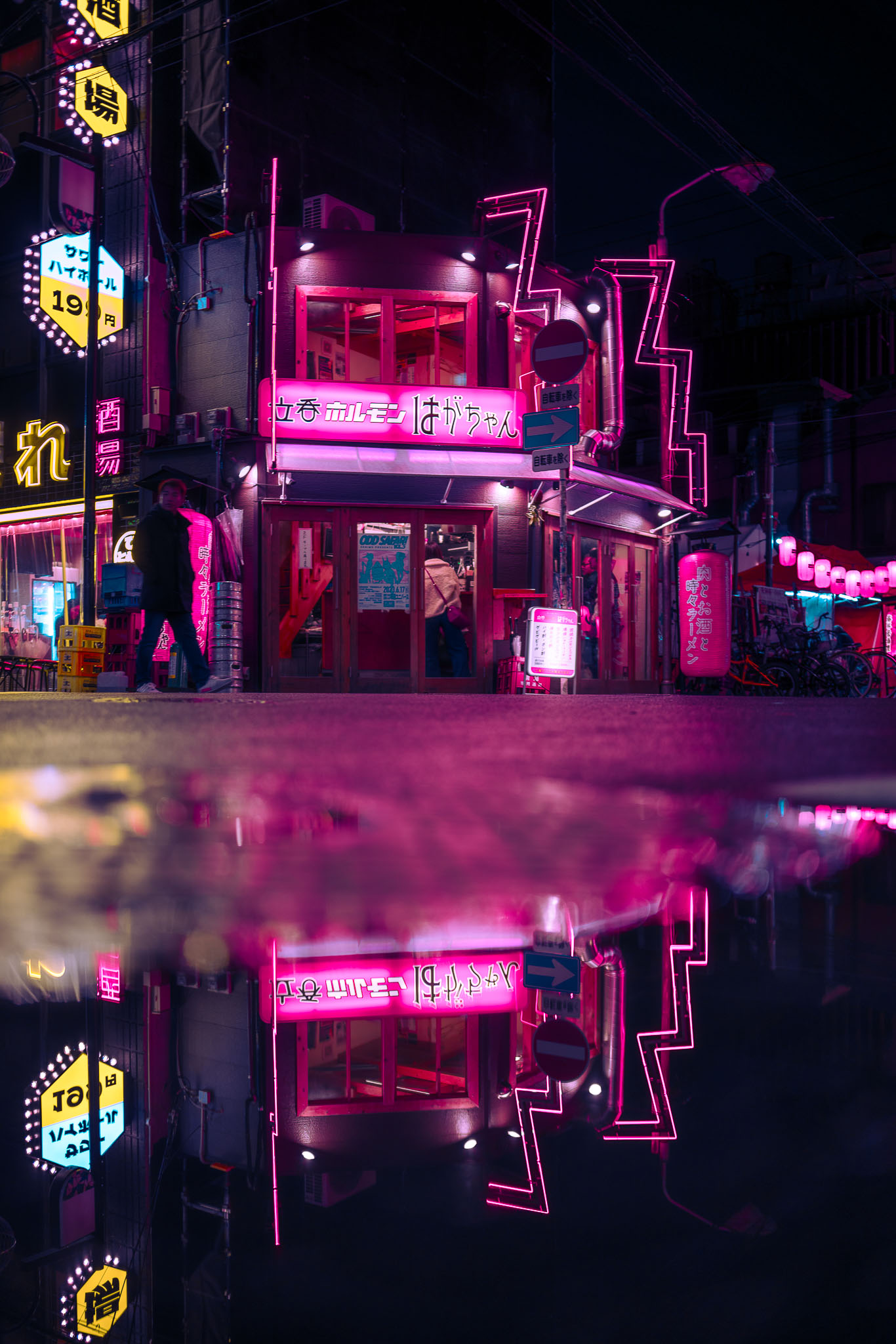 Osaka neon izakaya at night with pink puddle reflection and silhouette
