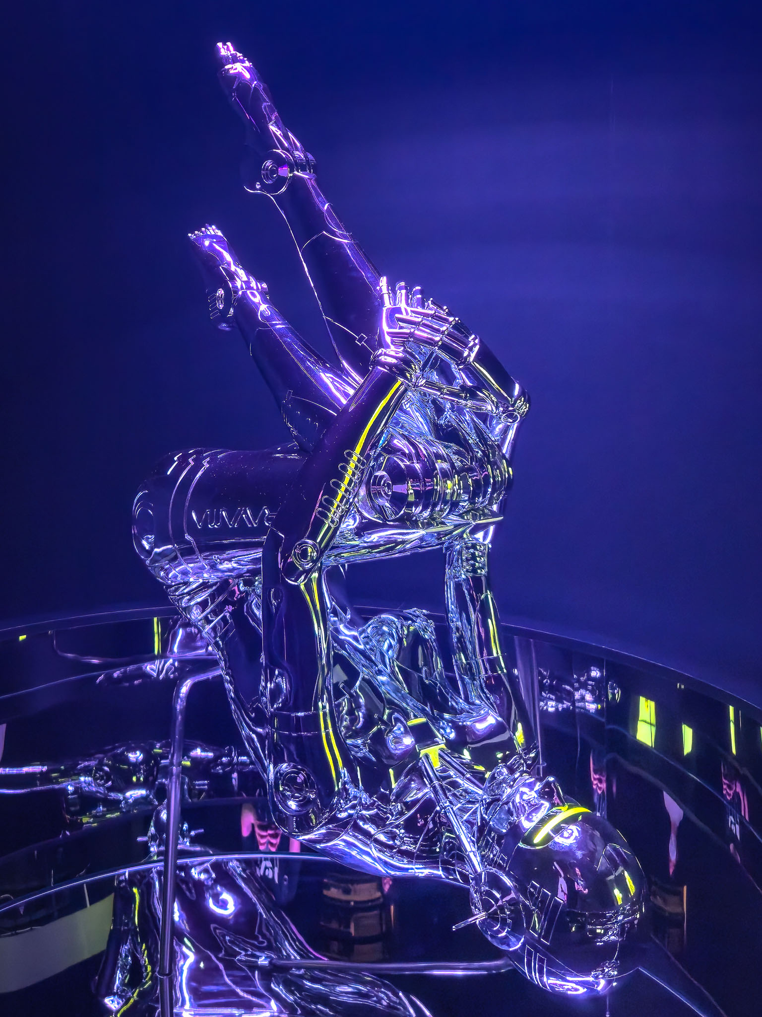Sorayama chrome robot sculpture under neon light — Tokyo exhibition