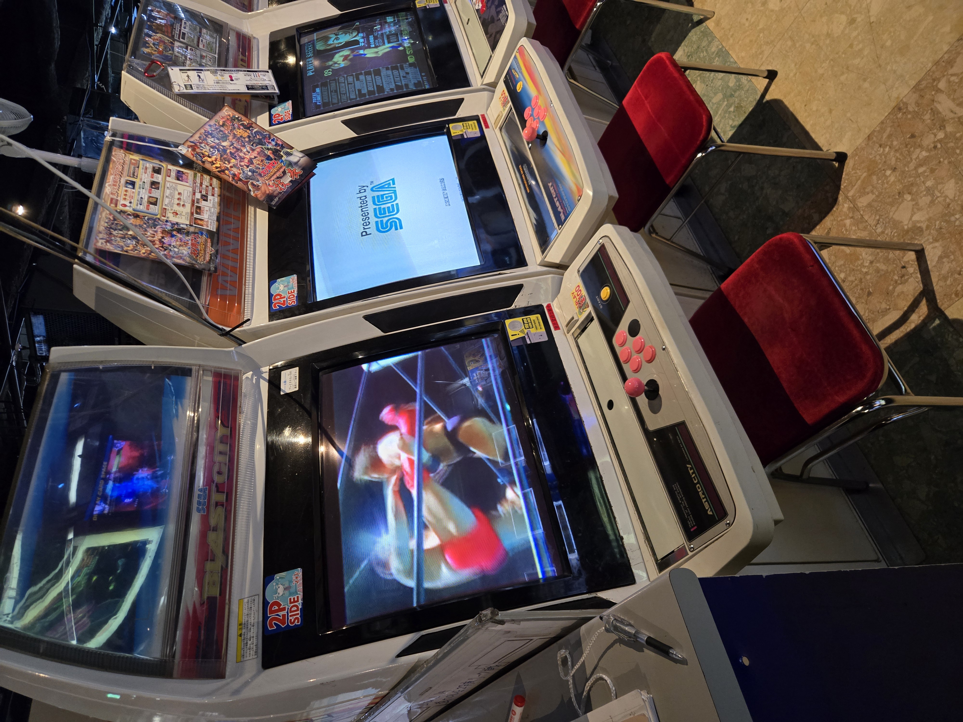 Fighting game cabinets with red velvet chairs at Game Center Mikado Takadanobaba