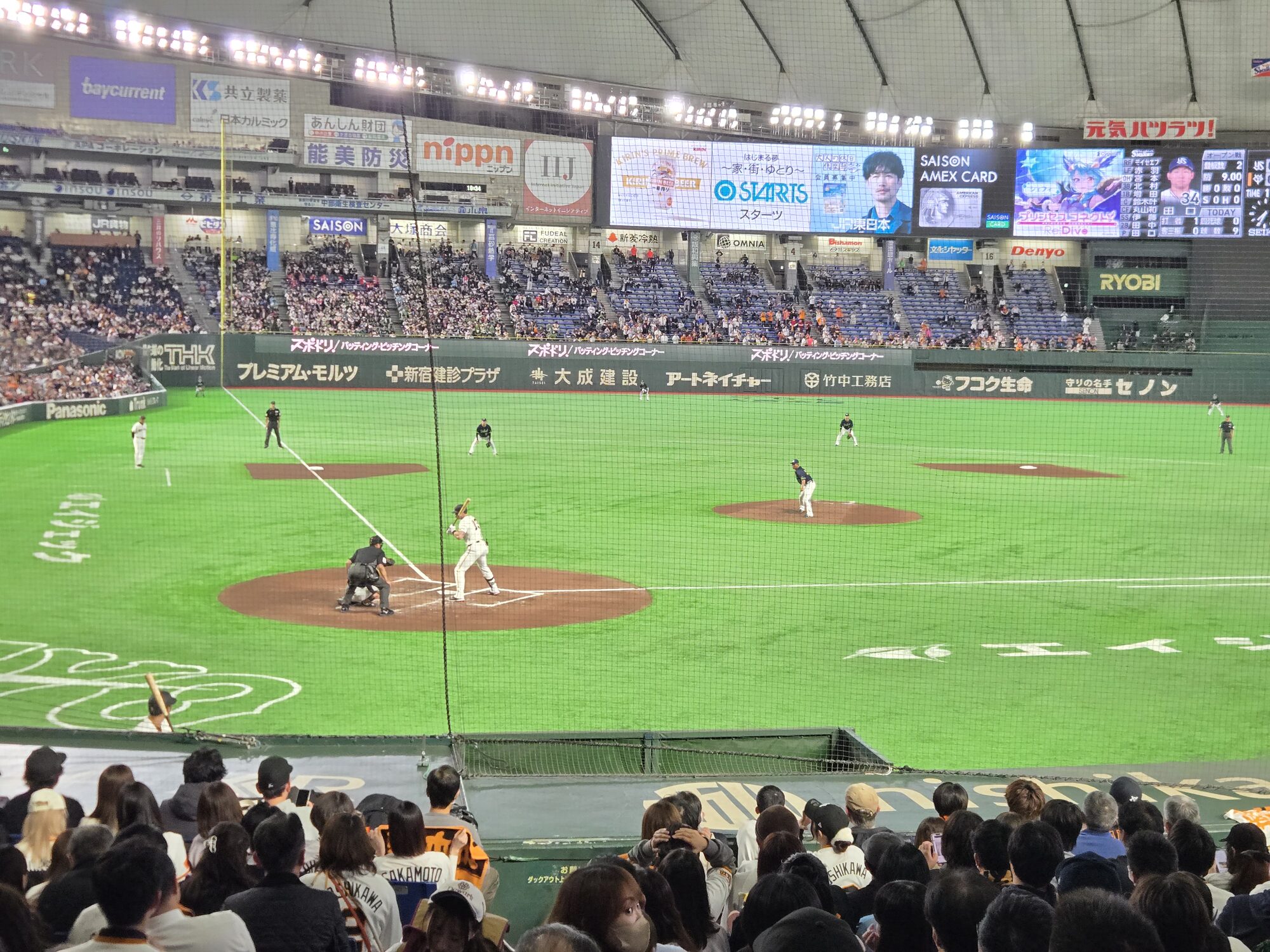 Batter at the plate during a Yomiuri Giants game at Tokyo Dome — infield shot from the stands